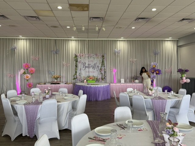 Round banquet table with a lavender runner and butterfly place settings