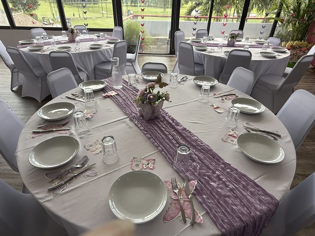 Banquet room with a floral butterfly backdrop and decorated tables