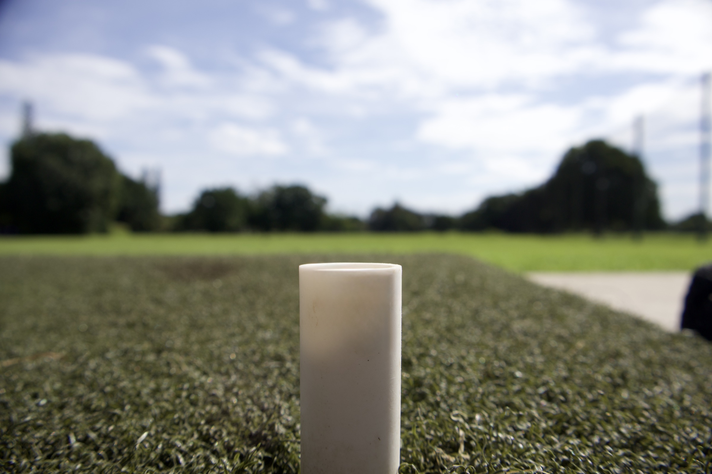 Close-up of a tee marker on the Redland Golf practice turf.